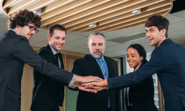 istock Executives in Formal Attire Mark a Momentous Business Partnership with a Handshake. Professional Colleagues Seal a Lucrative Business Deal with a Handshake and Contract Signing. 1699867431