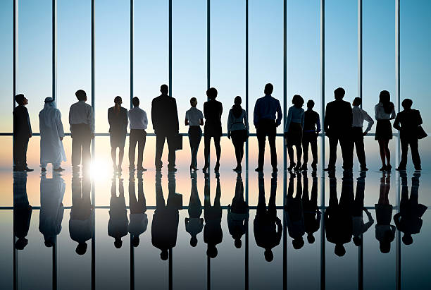 istock Business people silhouette staring at sunset. 169987078