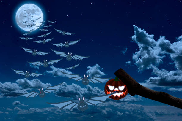 Supermoon rising over the Jack O' Lantern and flying bats in midnight.