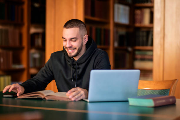 istock University student sitting in the library and using laptop for learning 1699873460