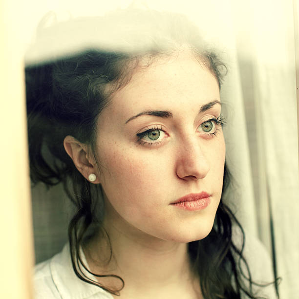 istock Teenage looking through window 169987615