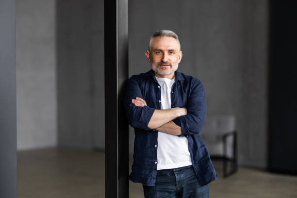 istock Happy middle aged good looking casual man at home, smiling. 1699878333