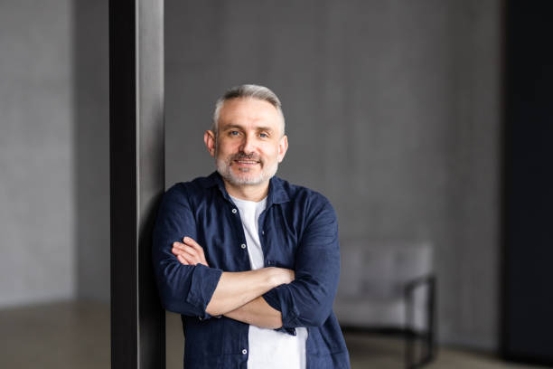 istock Happy middle aged good looking casual man at home, smiling. 1699878845