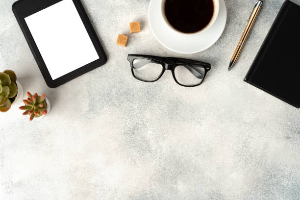 istock E-book reader, cup of coffee and glasses on gray surface 1699878862