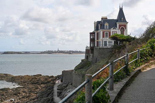 Dinard, Côte d'Émeraude, France, August 30, 2023 - Old Belle Epoque villa on the beach of Dinard, in the background Saint Malo, Brittany France