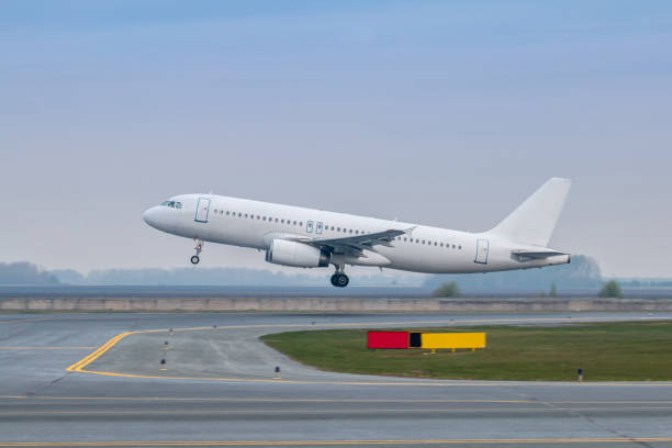 istock Take off of a white passenger airplane the runway 1699892223