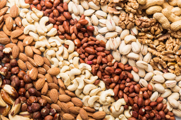 istock different nuts background. Close up, top view, flat lay. Walnut, pistachios, almonds, hazelnuts and cashews 1699897304