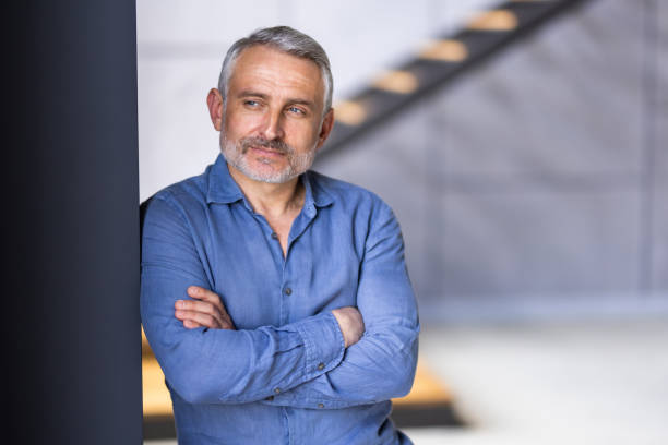 istock Bearded middle-aged man with a serious expression in a close up head and shoulders portrait 1699903313