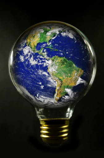 A round light bulb with a NASA view of earth in the bulb. Black background.