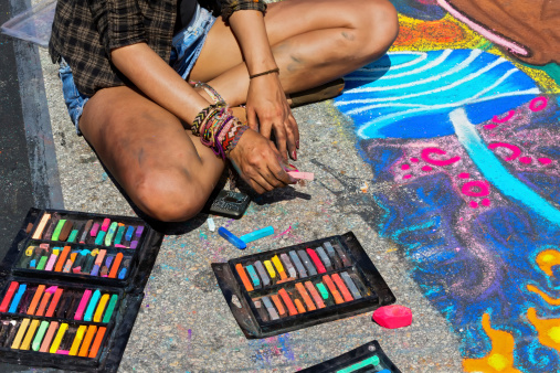 Woman artist working on chalk sidewalk RM.  rr