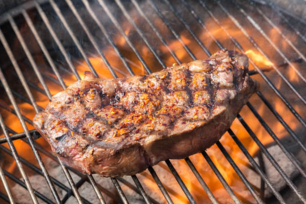 Kobe New York Steak on Grill with Fire Juicy New York steak on the grill kissed by fire Ribeye Steak stock pictures, royalty-free photos & images
