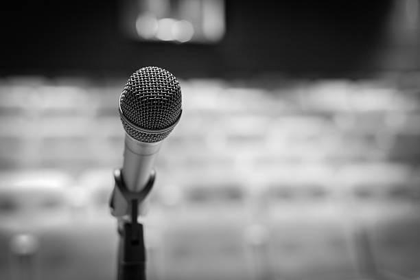 Microphone on stage (Black-and-white image) Microphone on stage (Black-and-white image) spokesperson stock pictures, royalty-free photos & images