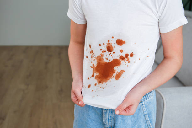 istock A white deodorant stain on black t-shirt. 1699937463