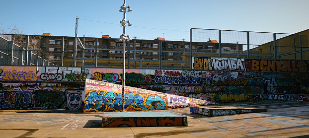 Barcelona, Spain - January 2020: Street art graffiti in public skatepark, Jardins de les Tres xemeneies in Paralel avenue. Wide shot. High quality photo