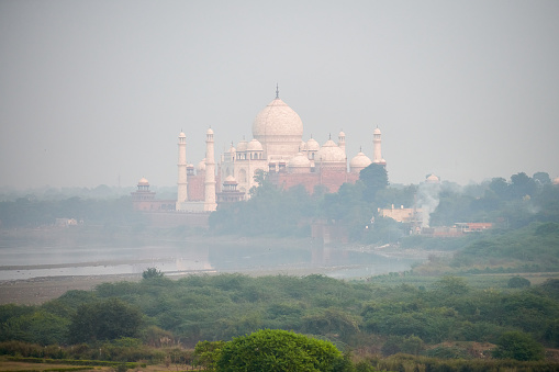 Taj Mahal white marble mausoleum landmark in Agra, Uttar Pradesh, India, beautiful ancient tomb building of Mughal architecture, popular touristic place view from Agra red Fort