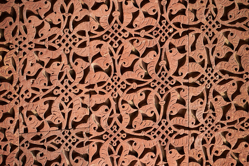 Wall decorative patterns of Qutb complex in South Delhi, India, close up ancient bas relief wall decorations of mosque ruins landmark, popular touristic spot in New Delhi, ancient indian architecture
