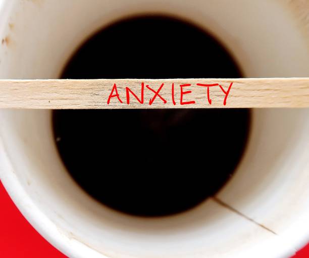 istock Blurred Coffee cup with text on stirrer ANXIETY, feeling of worry, nervousness or response to stress from imminent event - tension and worried thoughts 1699961691