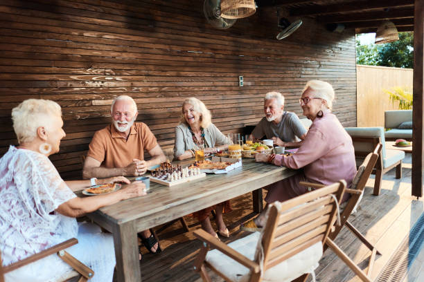 istock Happy seniors talking during social gathering at picnic table in the backyard. 1699962961