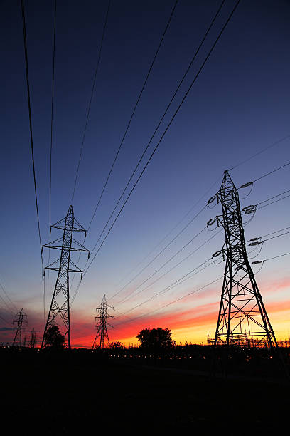 Electric Pylons and Lines at Sunset  buzbuzzer energy cable steel cable stock pictures, royalty-free photos & images
