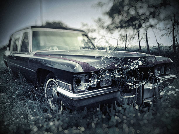 Old Abandoned Hearse in Cemetery stock photo