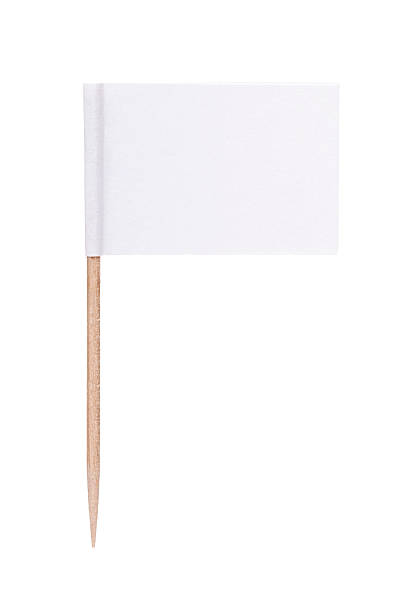 White paper flag with toothpick pole White paper toothpick flag. Nice paper texture. Isolated on white. cocktail stick stock pictures, royalty-free photos & images