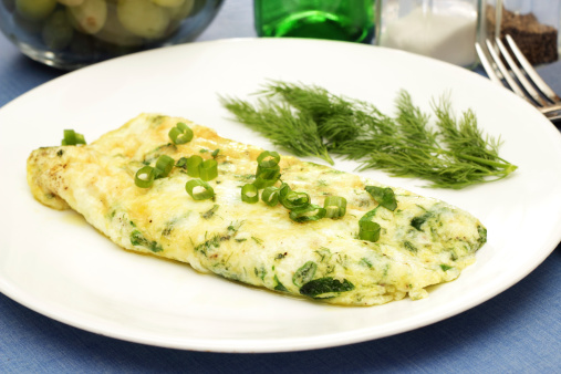 A heart healthy egg white omelet with fresh herbs and baby spinach