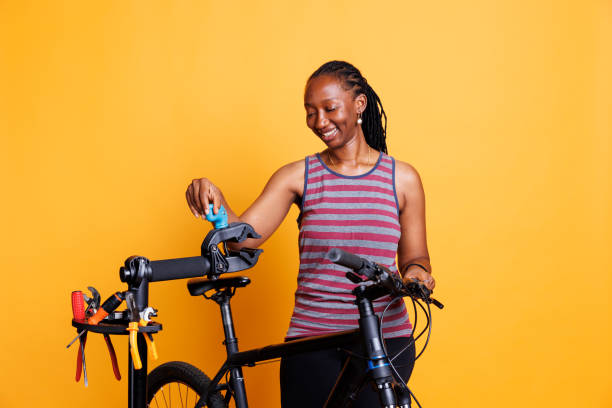 istock Black woman repairing bicycle with tools 1699988270