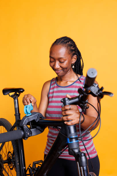 istock Black Female Cyclist: Bike Repair Time 1699992555