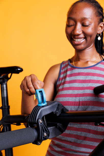 istock Skilled Black Woman Repairing Bicycle 1699993617