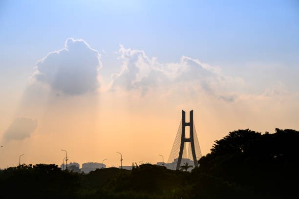 istock Bridge piers and city silhouette at sunset. 1700000151