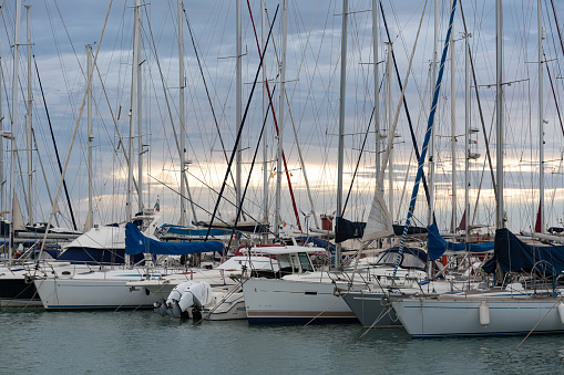 Lido di Ostia, Rome, Italy - September 2022: Row of luxury yachts mooring in a harbour