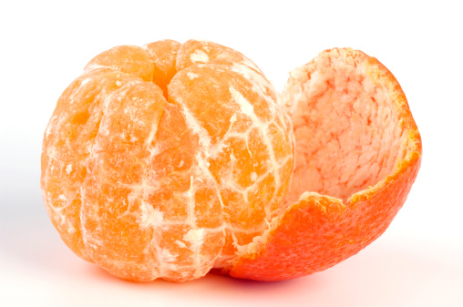 Fresh peeled tangerine with peel isolated on white background.