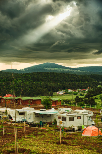 Caravans in caravan trailer park under dramatic sky at Niksar City in Turkey - HDR (High Dynamic Range Photograph)