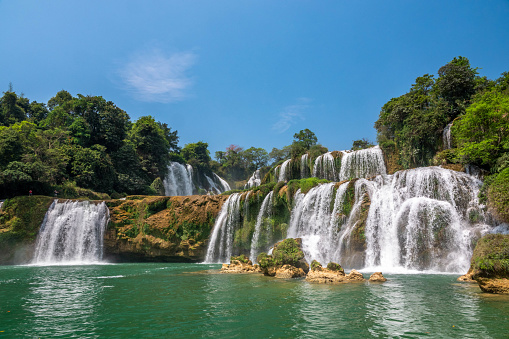 Ban Gioc Waterfall, also known as the Ban Gioc Detian Falls, this impressive waterfall is located in the Cao Bang province in Northern Vietnam. Much like other famous waterfalls in the world including Niagara and Iguazu, Ban Gioc Waterfall sits on the border between two countries, in this case, Vietnam and China. It is fed by the Quay Son River. The waterfall has multiple terraces, which only serves to make it more visually impressive. The surrounding scenery contributes to its wow factor too! Karst peaks and verdant valleys dot the area, making Ban Gioc Waterfall the perfect postcard scene.