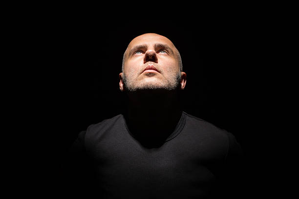 man in black a man alone in the dark  skinhead haircut stock pictures, royalty-free photos & images