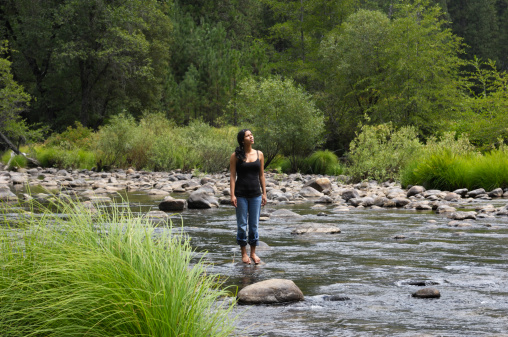 Pretty young latina woman and mountain river.