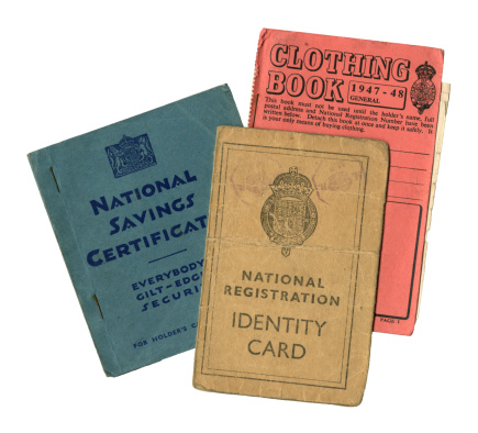A group of three pieces of British personal paperwork dating form just after World War Two, comprising a National Savings Certificate holder’s book, a Clothing Rationing Book and a National Registration Identity Card.