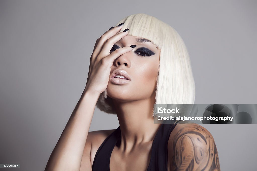 Attractive beauty Portrait of a young mixed race woman woman with a blonde hair wig Haute Couture Stock Photo