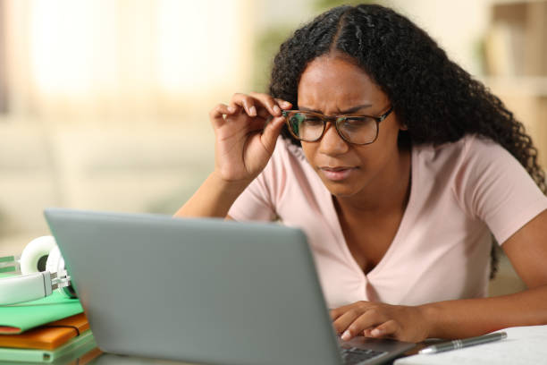 Black student wearing eyeglasses forcing sight