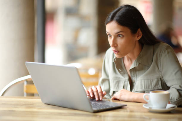 istock Amazed woman watching surprising content on laptop 1700016605