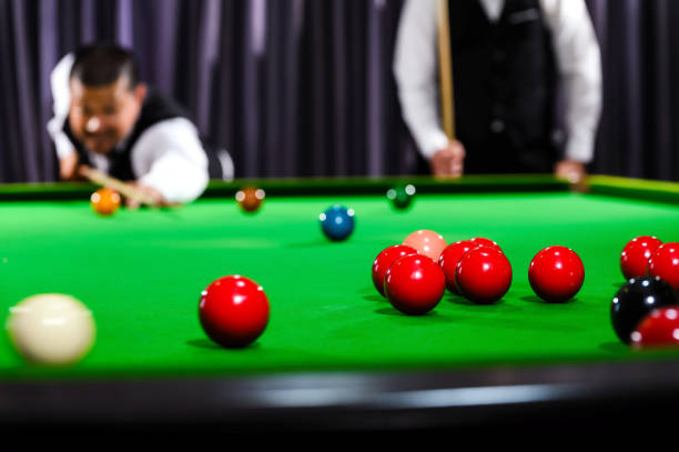 istock Snooker red ball with snooker player blur in background while aiming red ball on snooker table. 1700019650