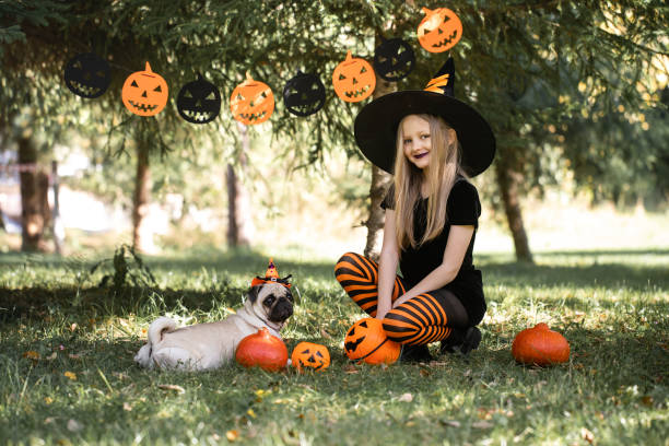 istock Halloween girl and dog 1700038417