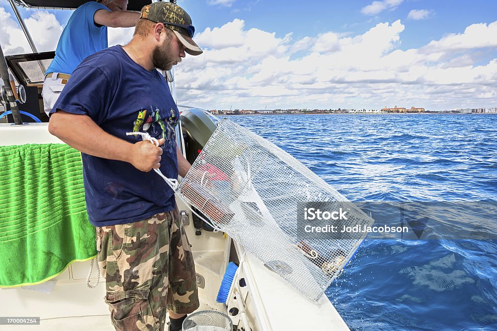 Fisherman throwing a crab trap Crabbing Stock Photo