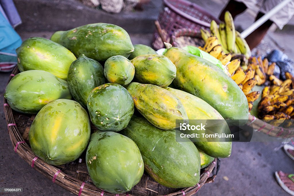 Papayas Papayas for sale, with plantains in background, at street market in Cebu, Philippines, Asia. City Stock Photo