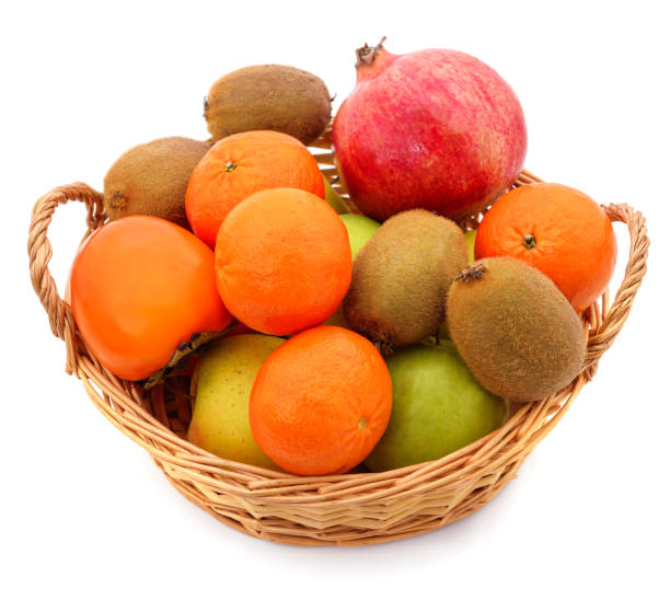 istock Tangerines, pomegranate and kiwi in a basket. 1700047860