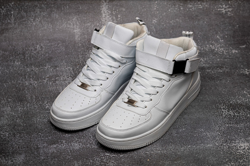 Leather white men's sneakers. Men's casual sports shoes. Fashionable sneakers