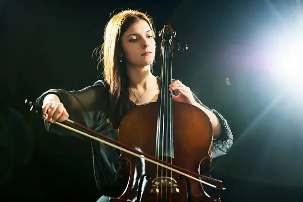Beautiful young woman playing cello.