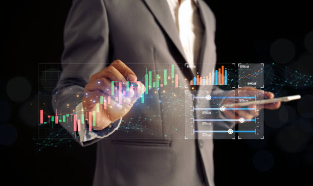 istock Human finger holding a pen. Touch screen. Virtual screen with stock market changes. Business candlestick charts show the increasing flow of numerical mechanics. Stock market report table 1700060725