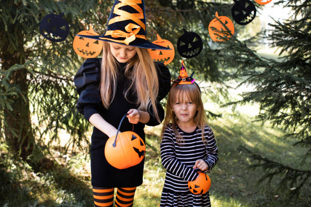 istock Girls dressed up as witches for Halloween 1700064183