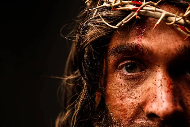 Jesus Christ looking at camera. This stock image has a horizontal composition.